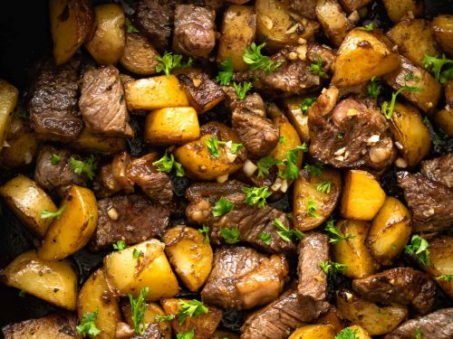 这道亚洲牛排土豆食谱的特色是烤牛肉块和土豆，配以大蒜黄油和酱油。它在30分钟内完成，所有的东西都在一个平底锅里煮好。简单的工作日晚餐!